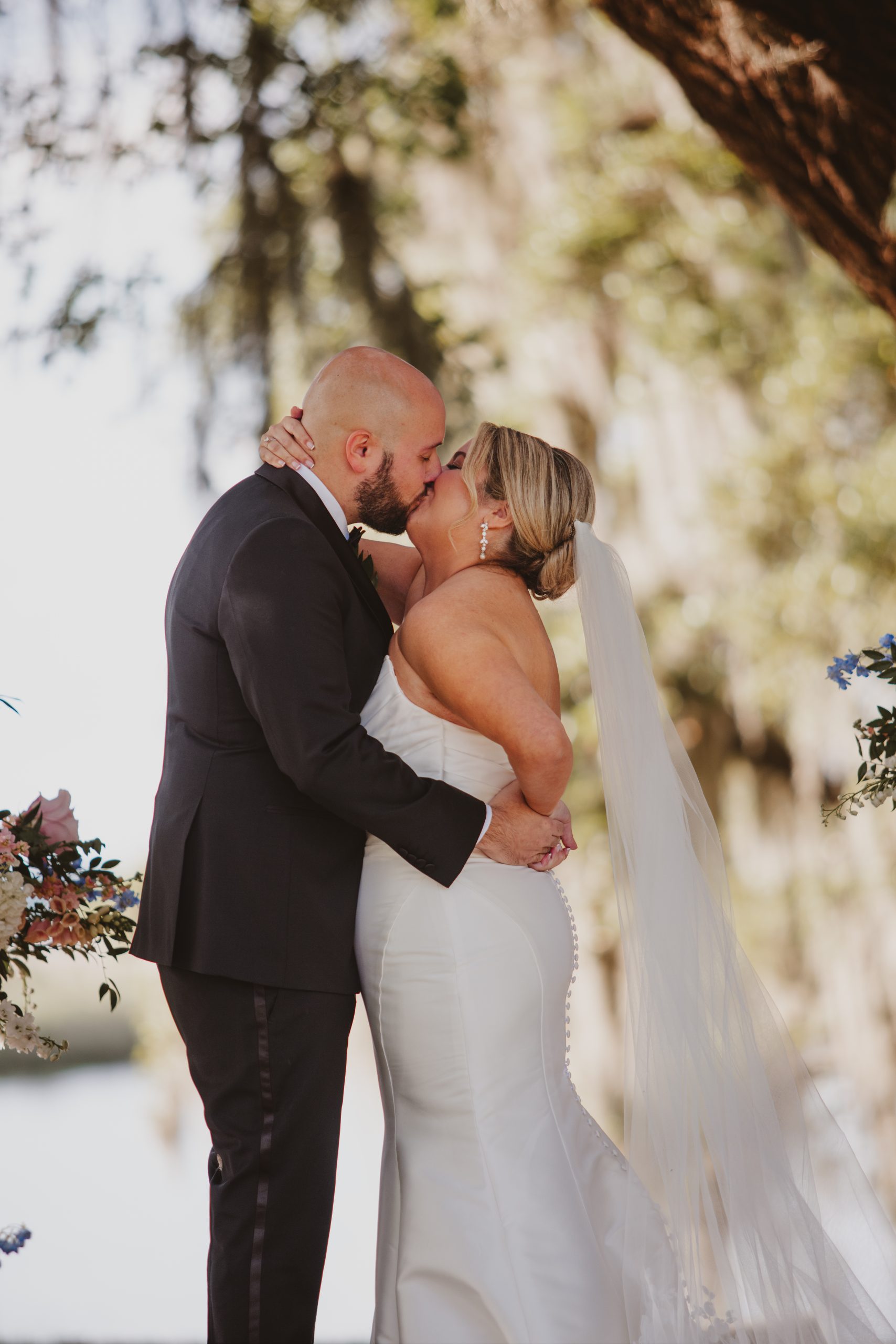 Charleston Wedding Photographer captures bride and grooms first kiss at Middleton Place. 