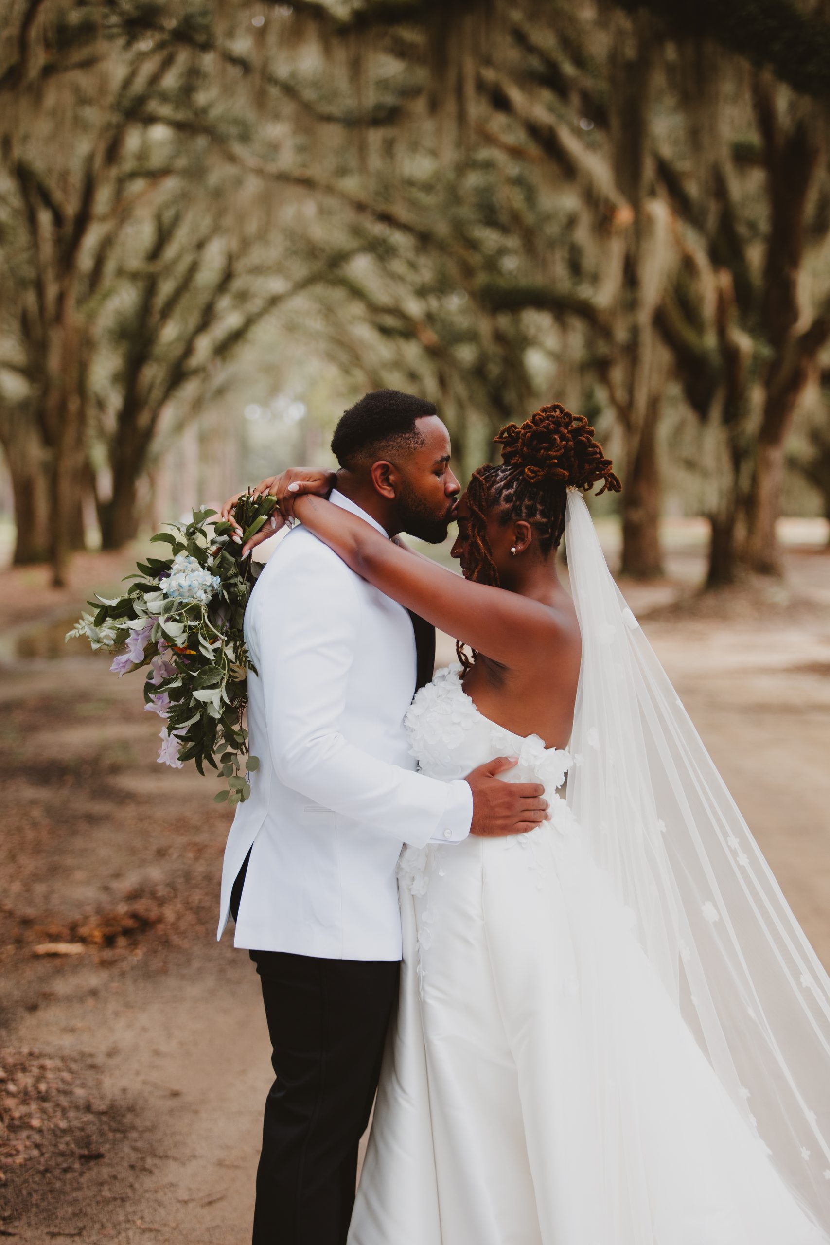 Charleston wedding photographer captures bride and groom formals under a canopy of live oaks at Eden at gracefield