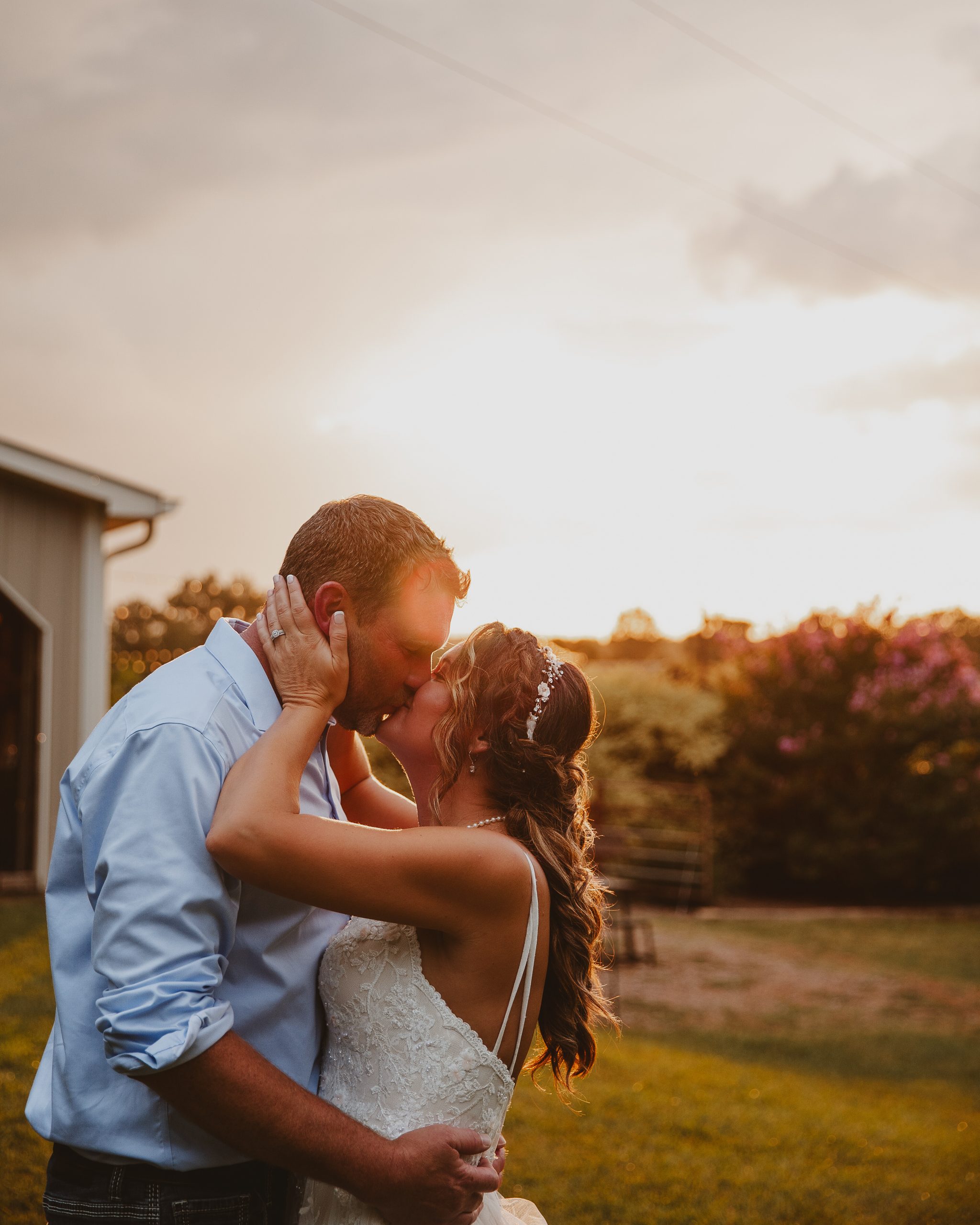 0aa3887e-9372-4e05-bf86-42bc0af2a15f Charleston photographer captures sunset kiss between bride and groom at their rustic wedding.