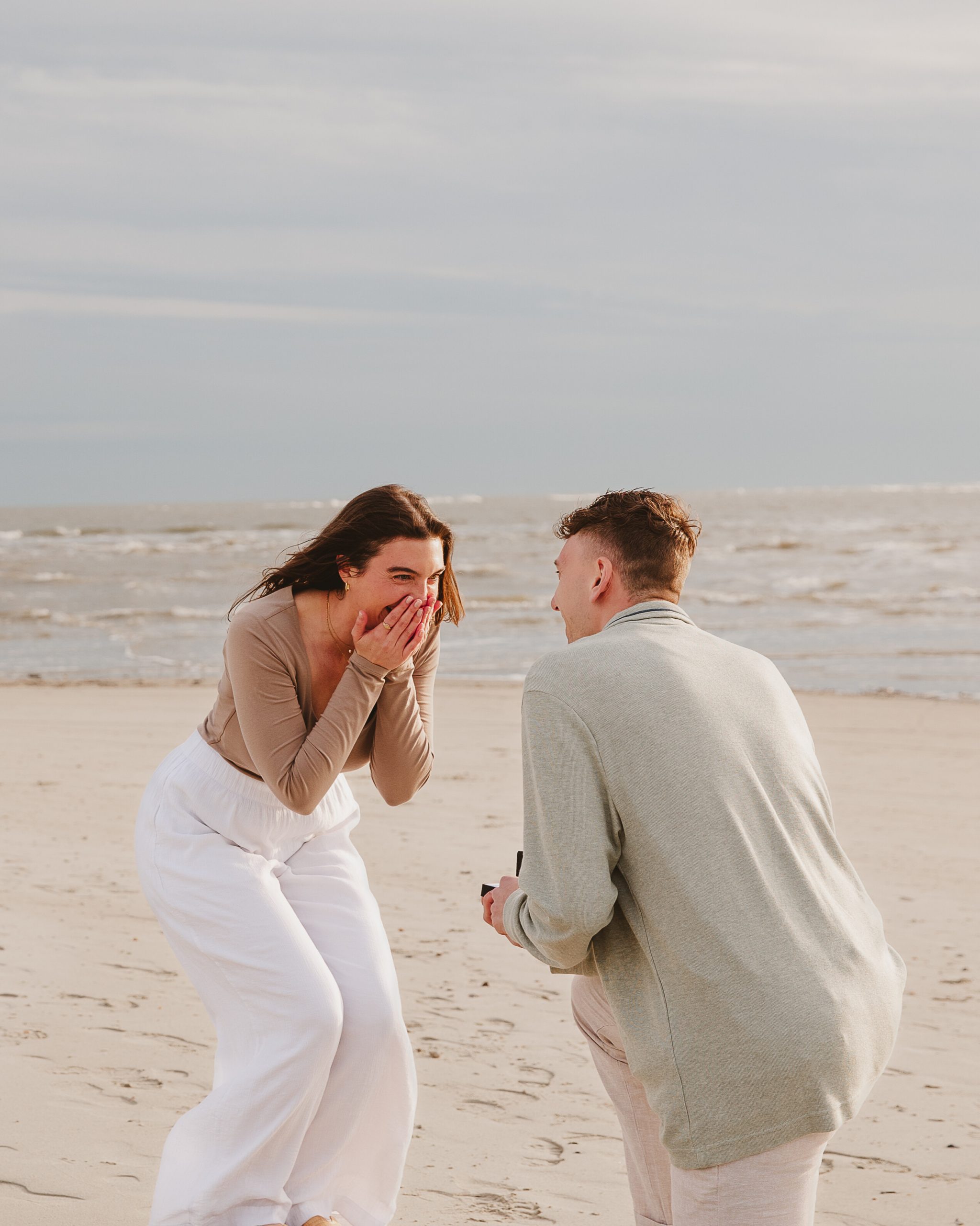 7e8448a9-ffcd-4daa-af0a-c7873e215fd7 Charleston engagement photographer captures proposal on Isle of Palms beach.